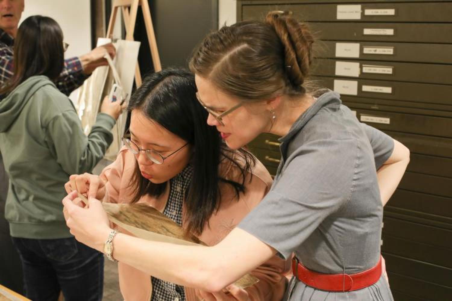 Female faculty and female student looking at a map