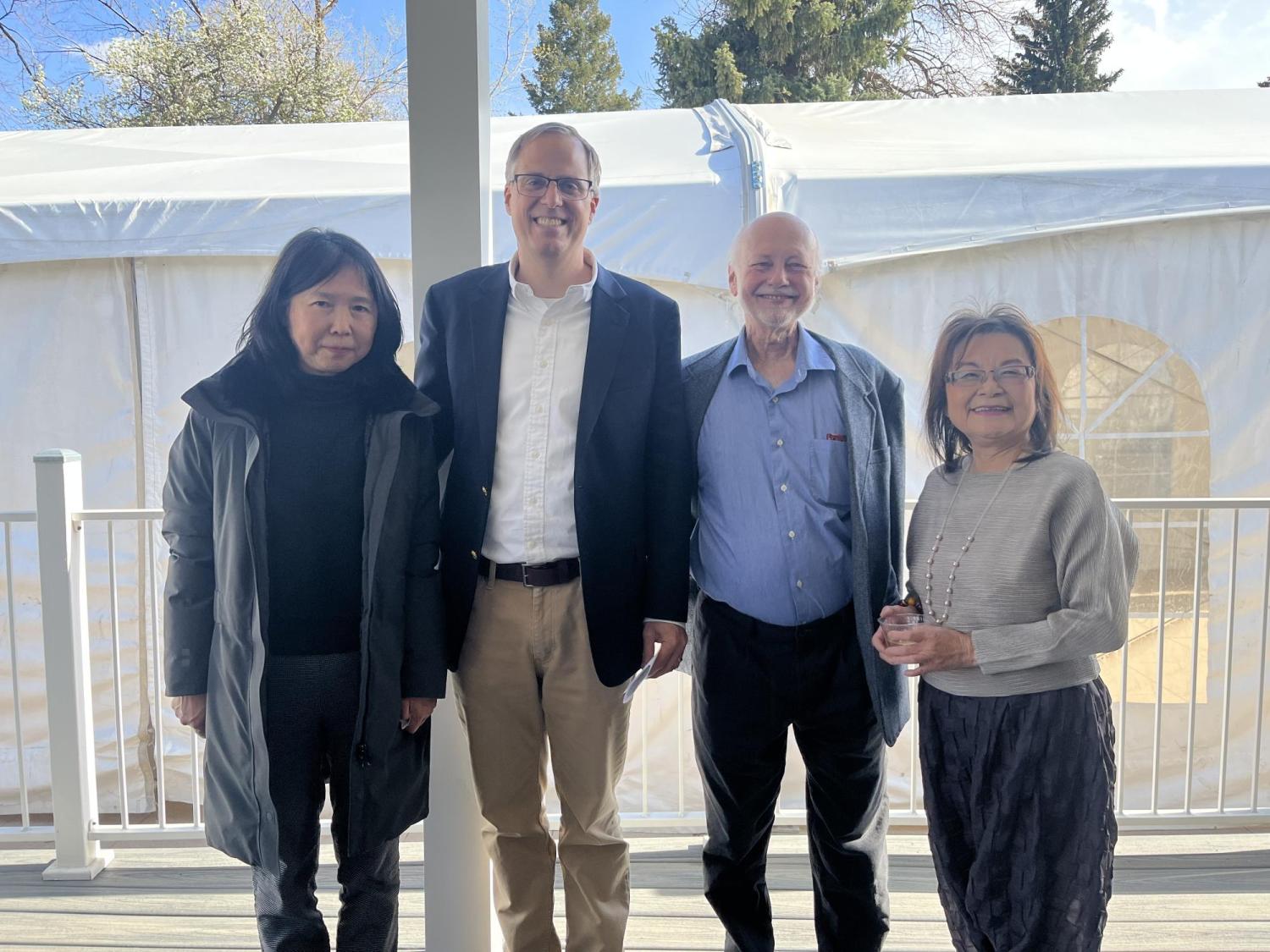 Four faculty member standing and smiling