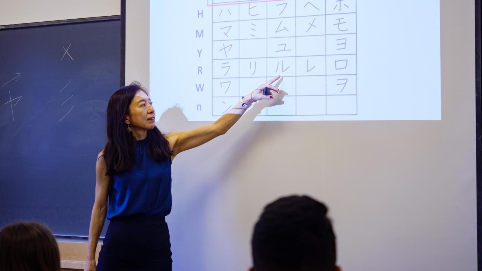 A female instructor teaching katakana