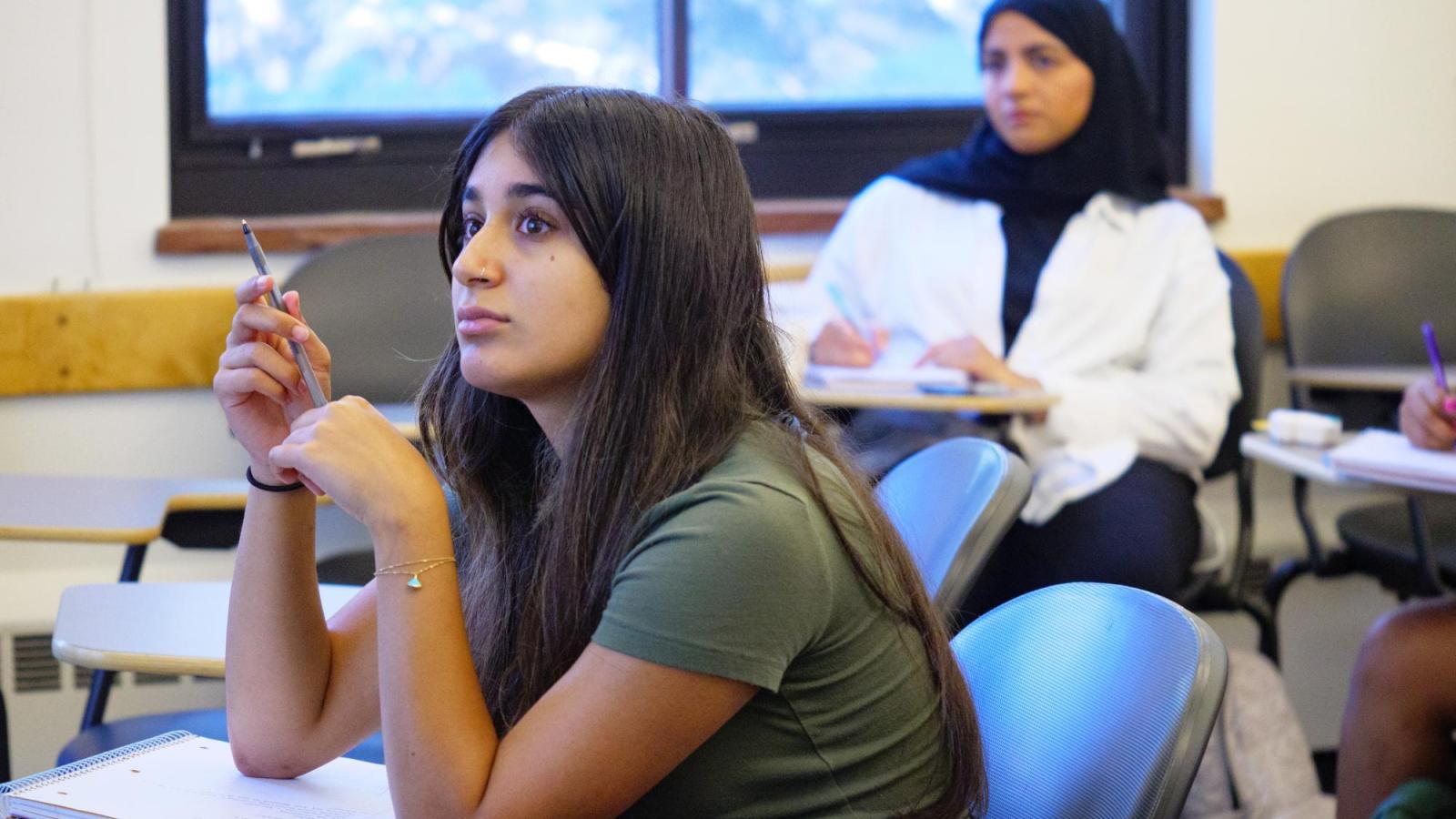 Female students paying attention to the presentation
