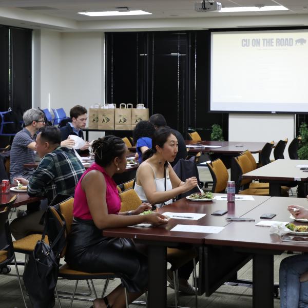 People sitting at tables at event