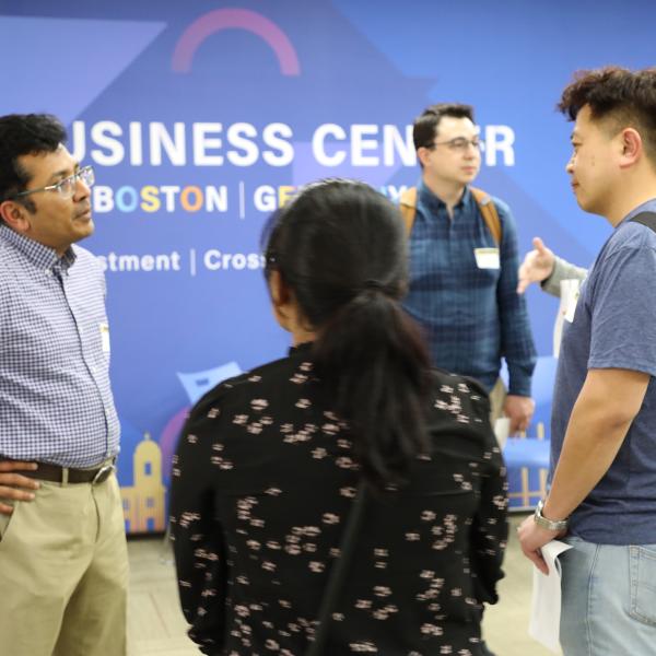 3 people standing in discussion
