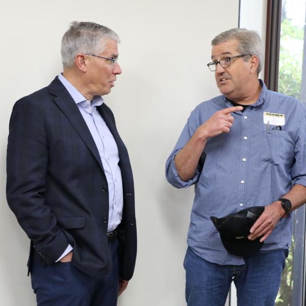 2 men standing in discussion