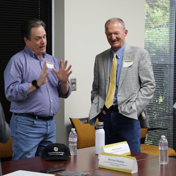 2 men standing in discussion