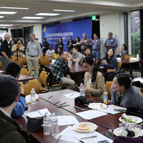 Crowd of people sitting, standing, at event