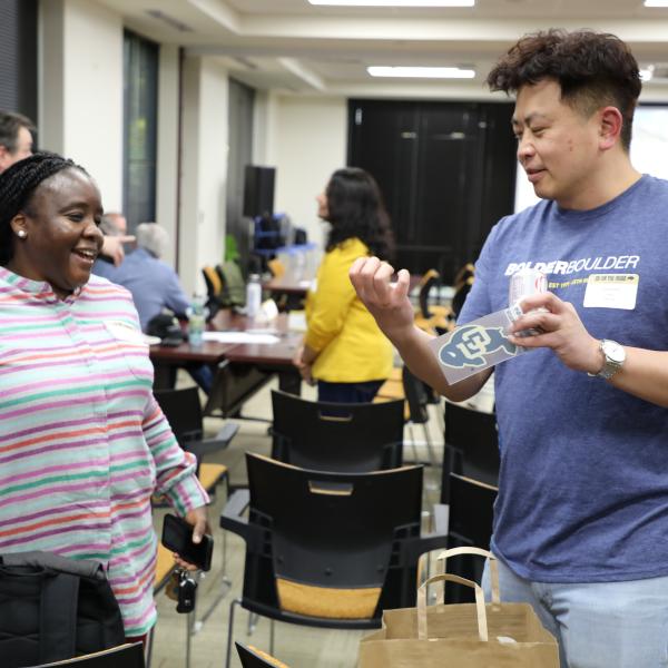 2 people standing, talking