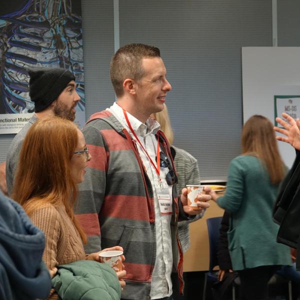 Robert Erickson speaking with other attendees
