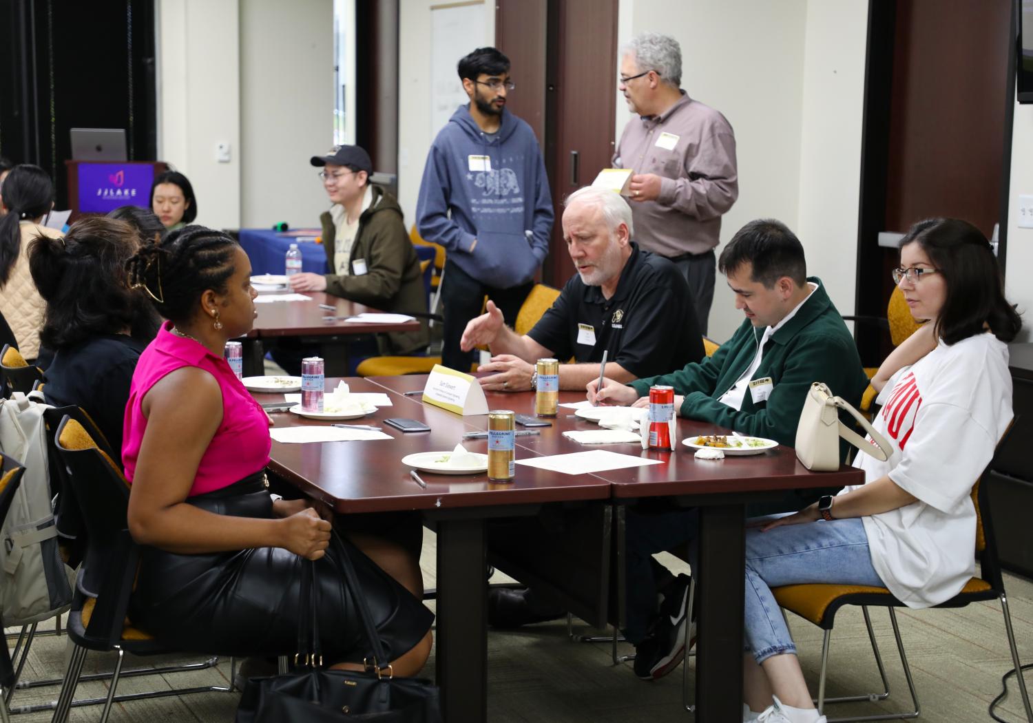 Group of people sitting at a table in discussion