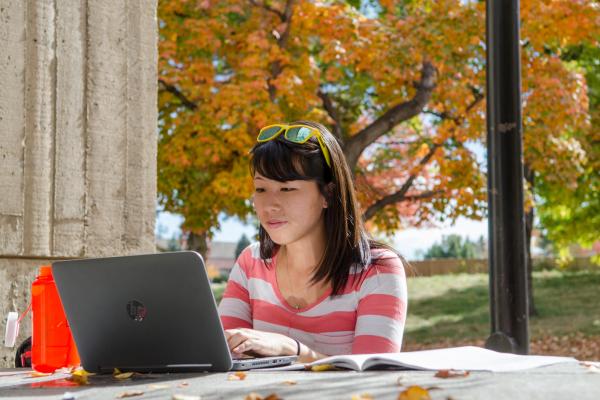 girl at table with laptop