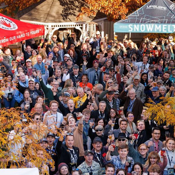 A large group of CU Boulder alumni and friends gather at the Alumni Association for a tailgate before the Homecoming football game