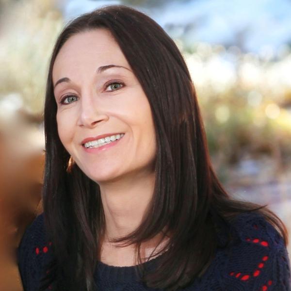 Photo of Alumni staff member Heidi Riley with a blurred nature background.