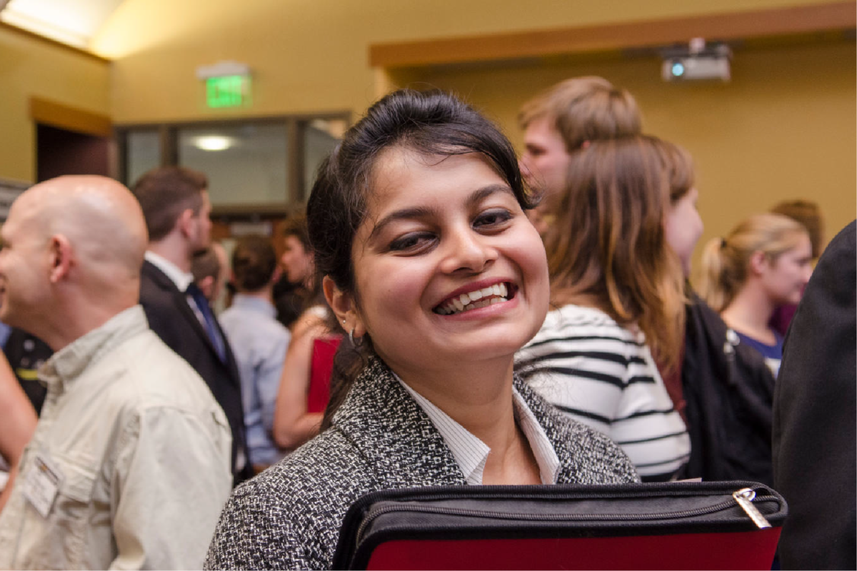 young CU alumn at a career networking event