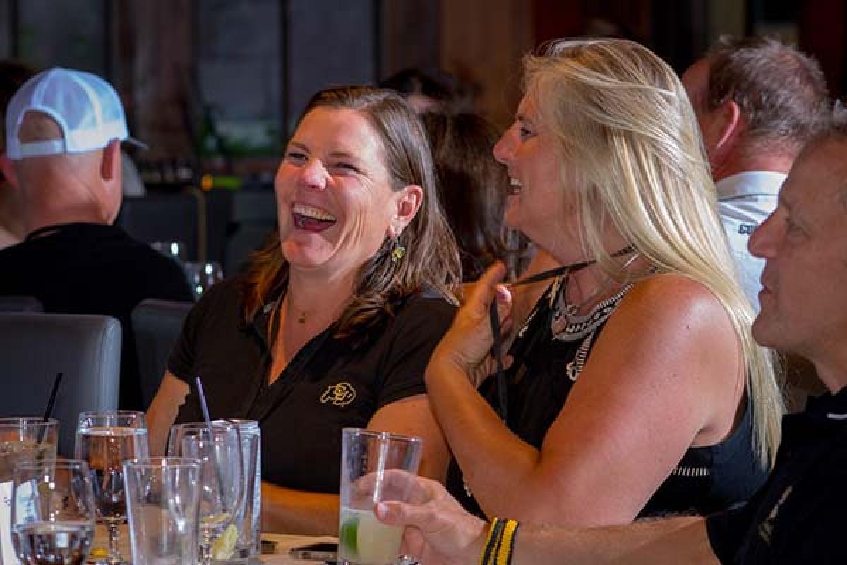 ForeverGold members laughing at an exclusive event