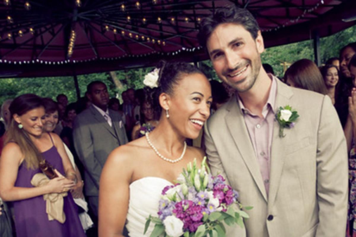 a bride and groom smile as they are married on cu boulder campus