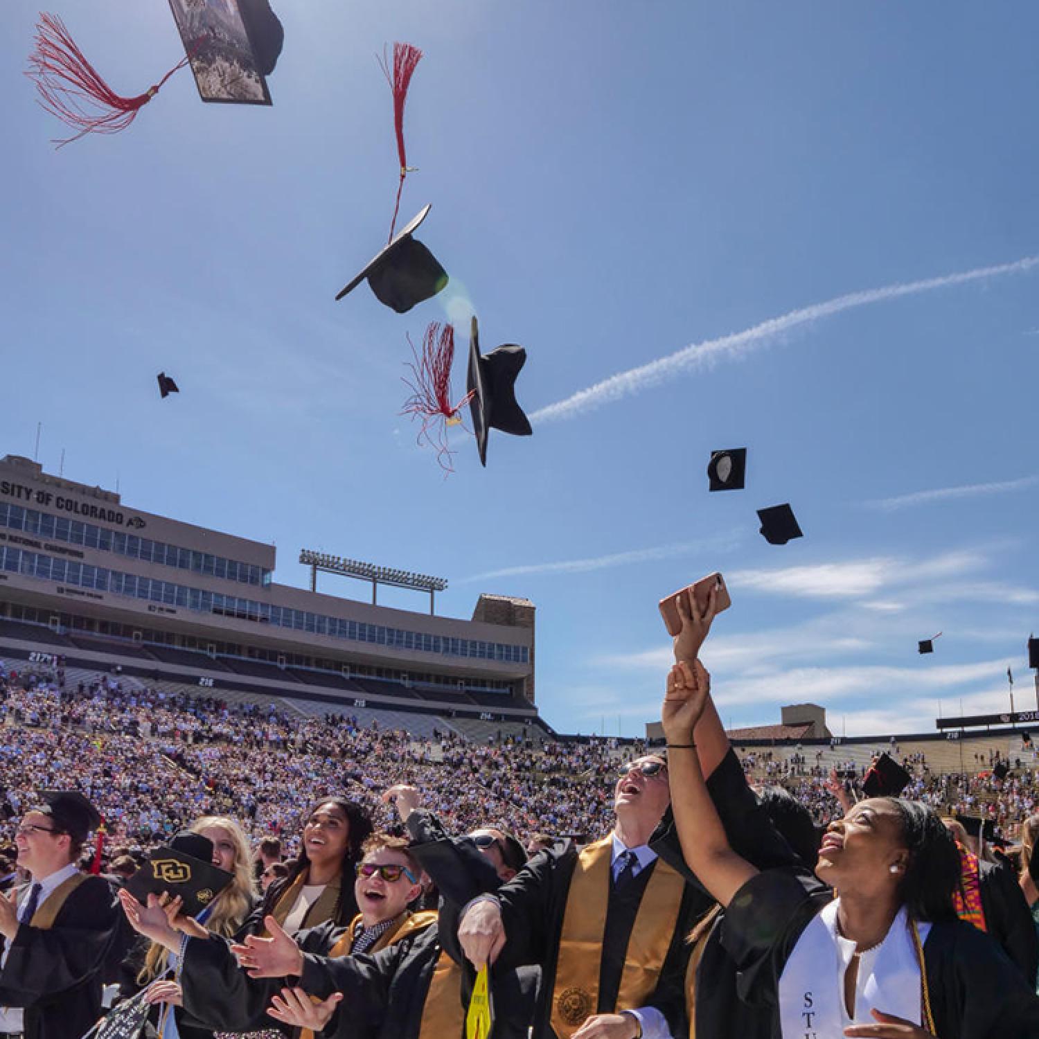 Graduates throwing caps in the air