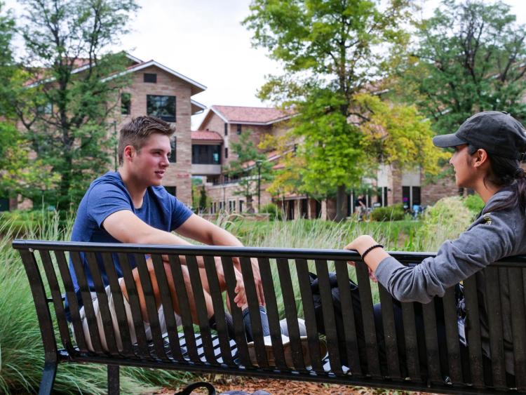 Two students sitting and talking