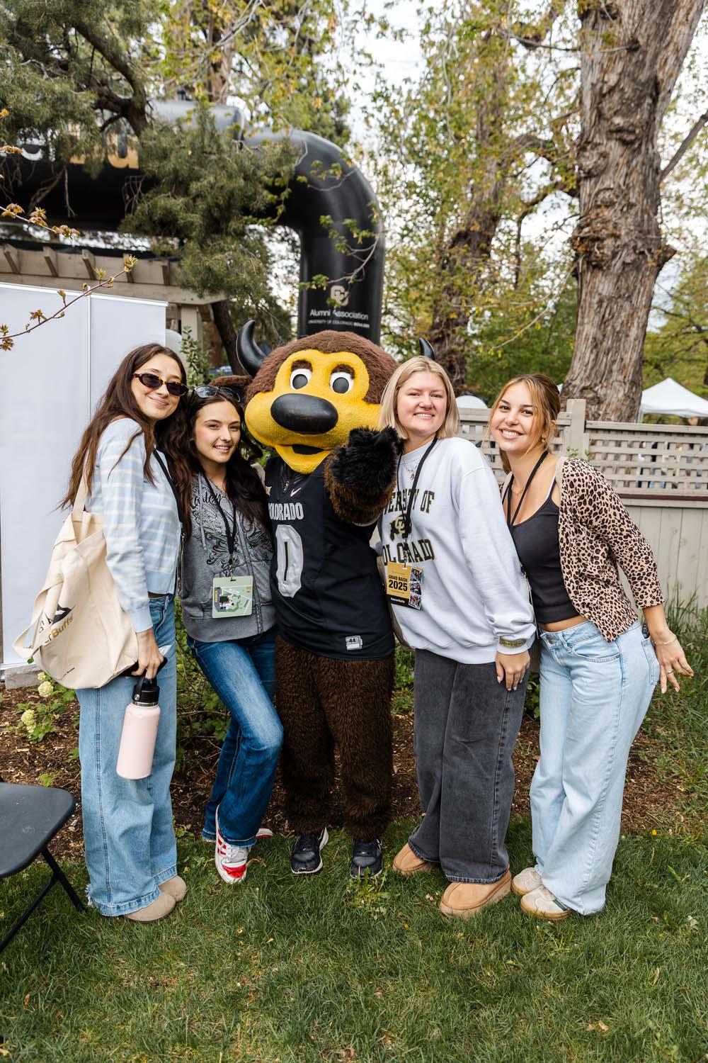 The CU Boulder mascot Chip poses with a group of students