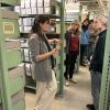 A group of people standing in the library archives.