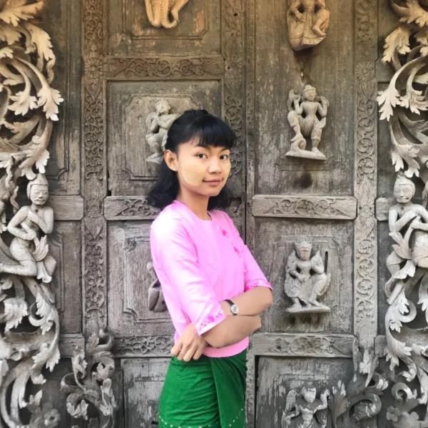 Chu Paing in front of an ornate door