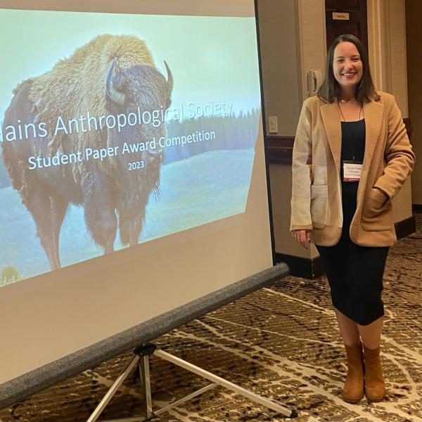 Kesley in front of her paper presentation