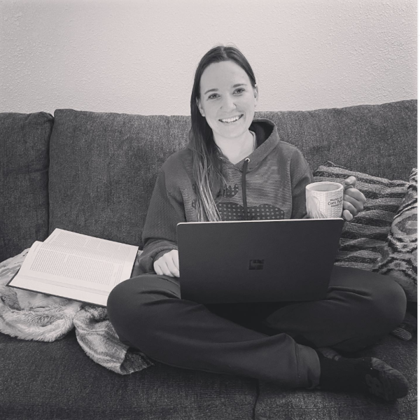 Kelsey on the couch with her laptop