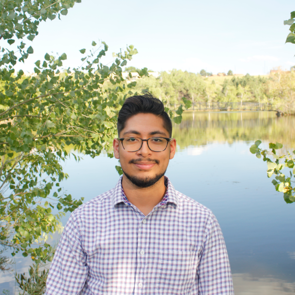 Nicholas in front of a pond