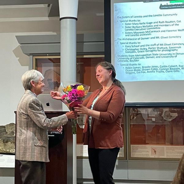 Professor Hosek receiving flowers from the Sisters of Loretto