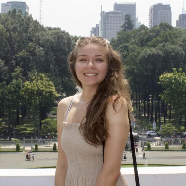 Lisa in front of a city skyline