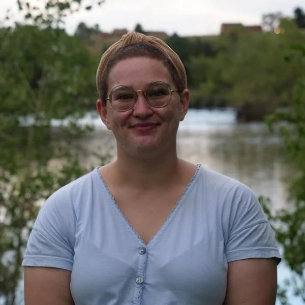 Sasha in front of a pond