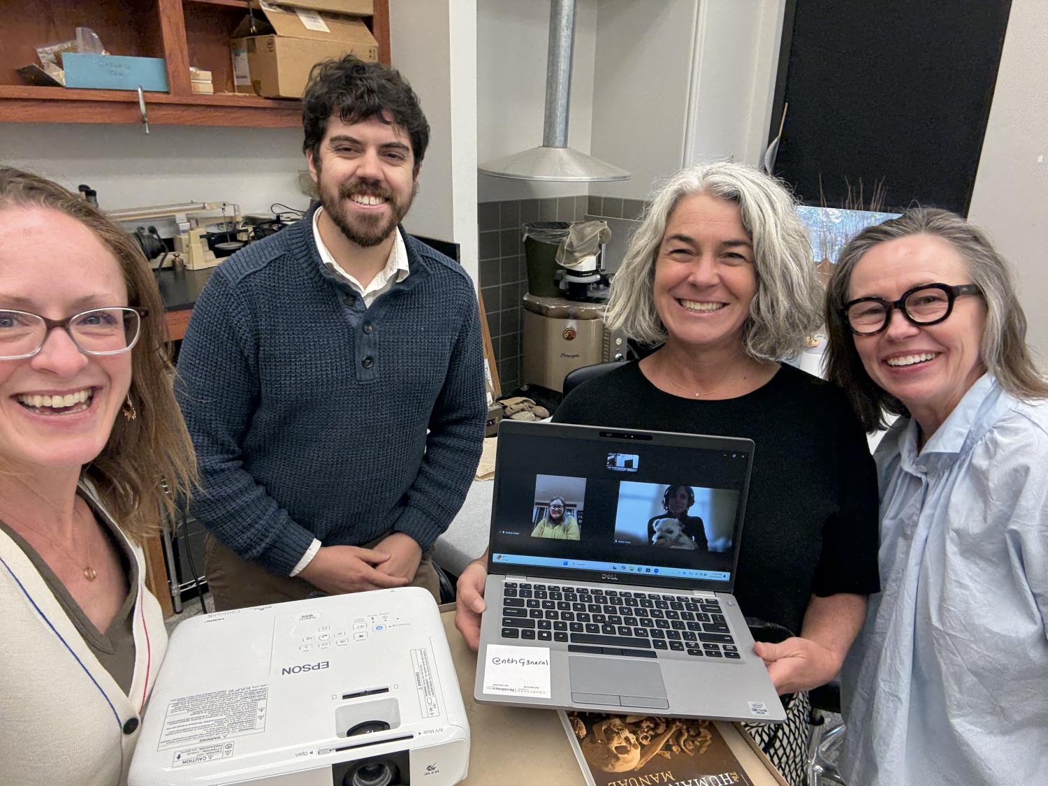 Kate, Anden, Carole holding a computer and Carla