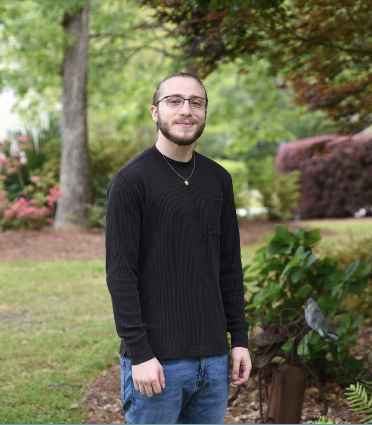 Aaron Lamskin standing next to a tree