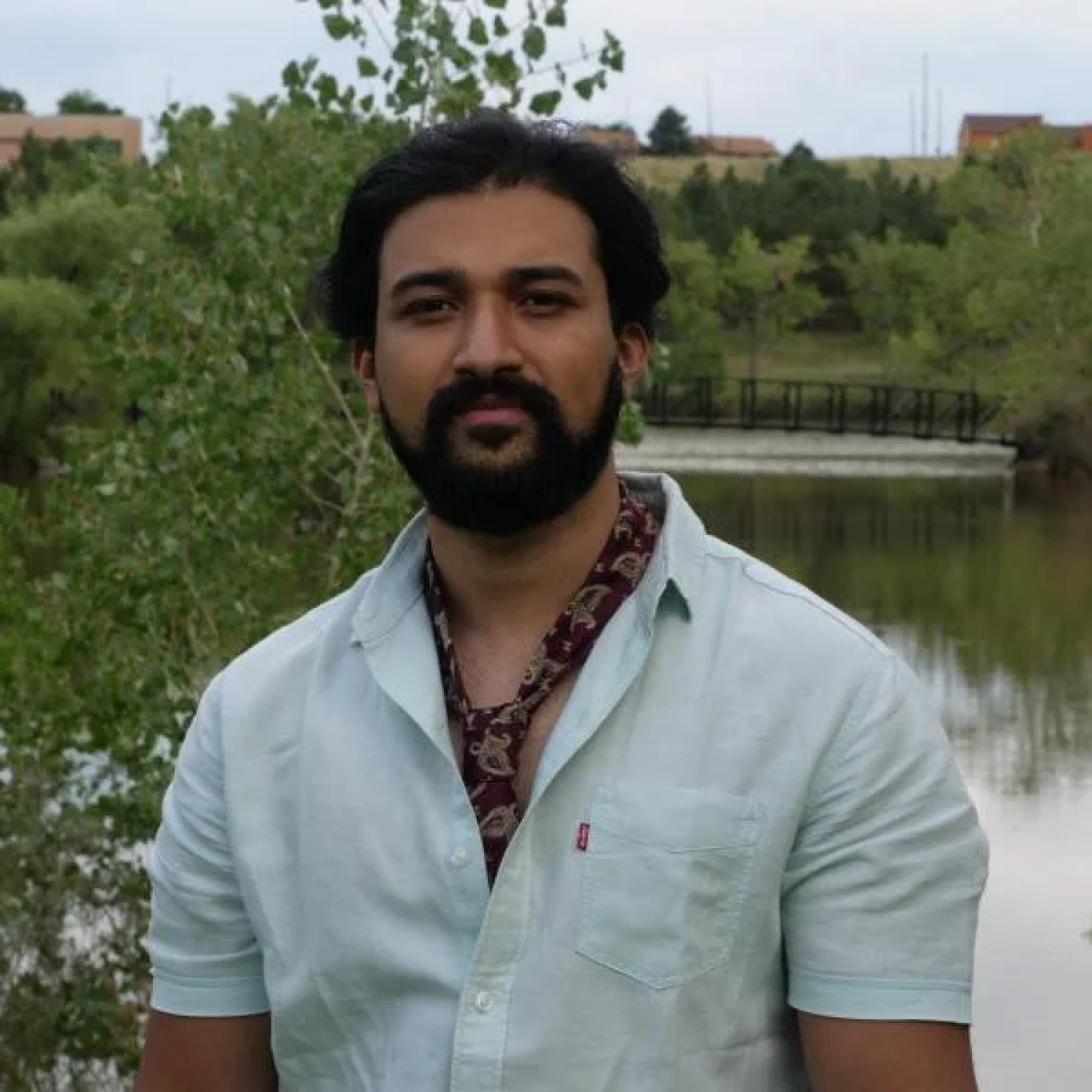 Adi in front of a pond