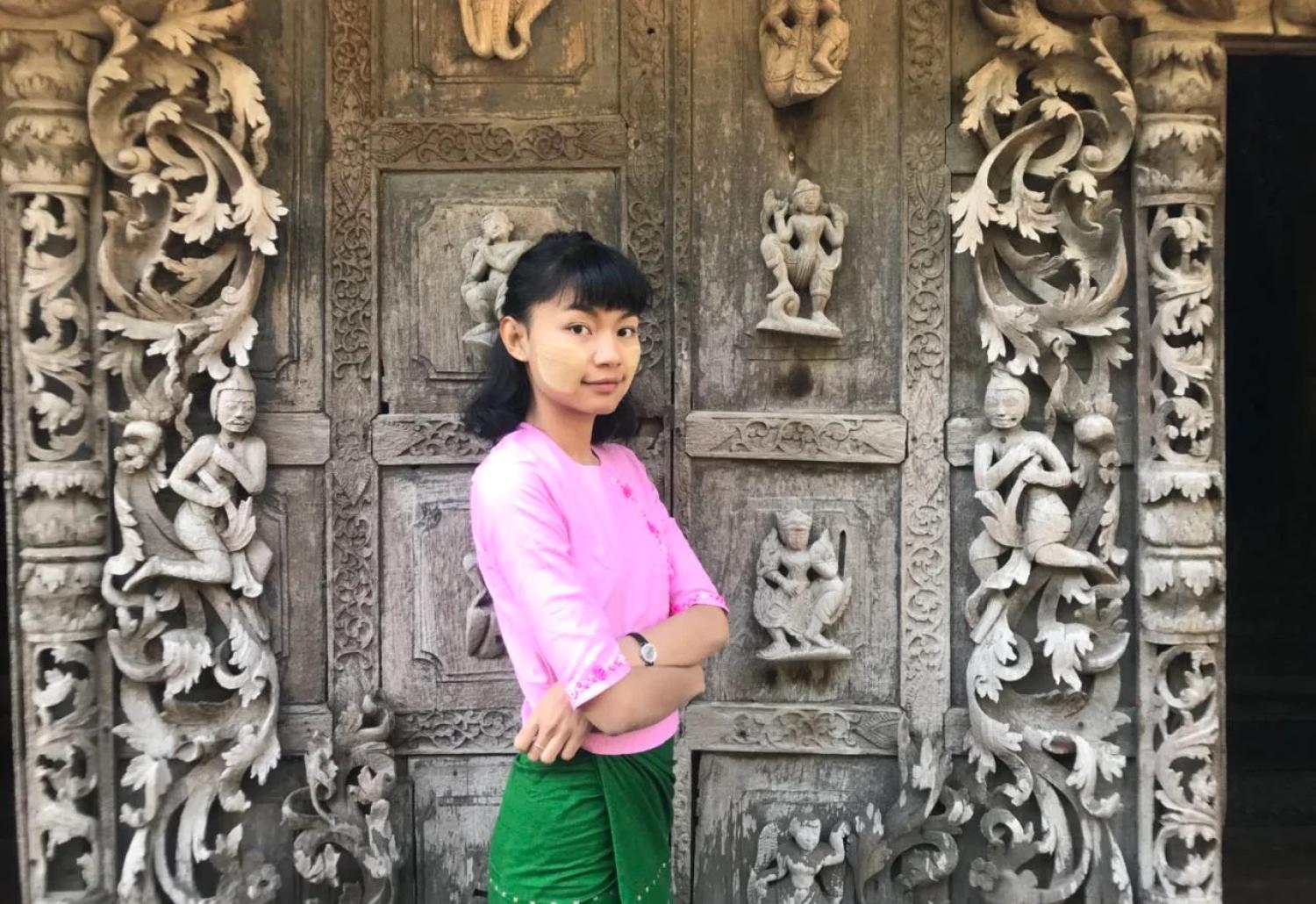 Chu Paing in front of an ornate door