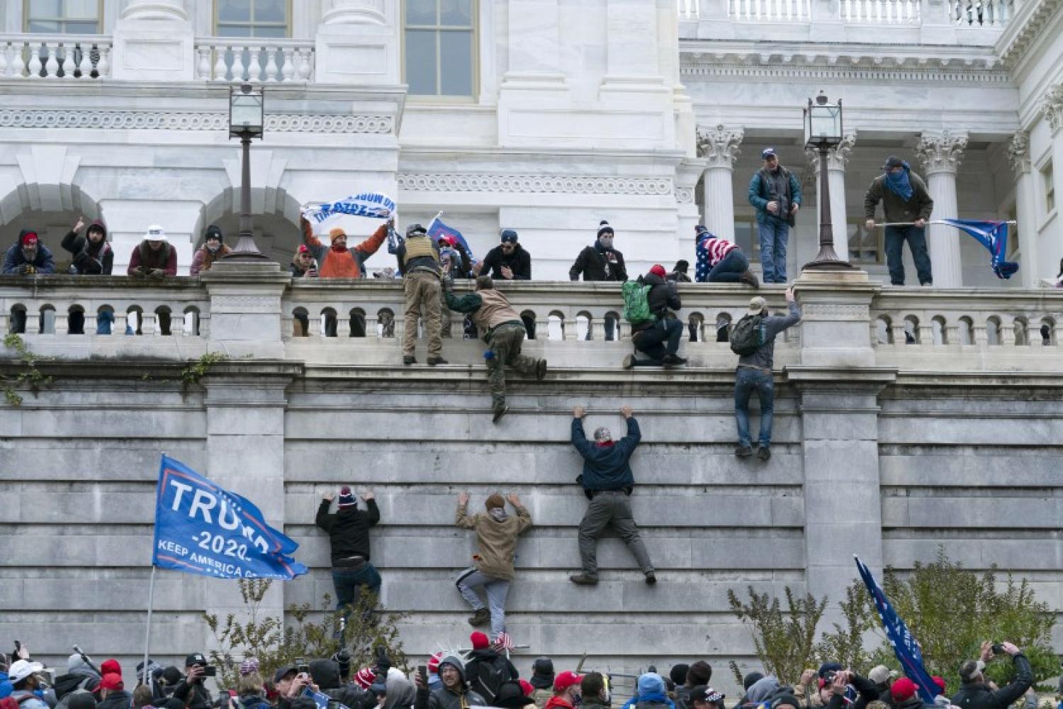 Trump supporters climbing the capital building in DC