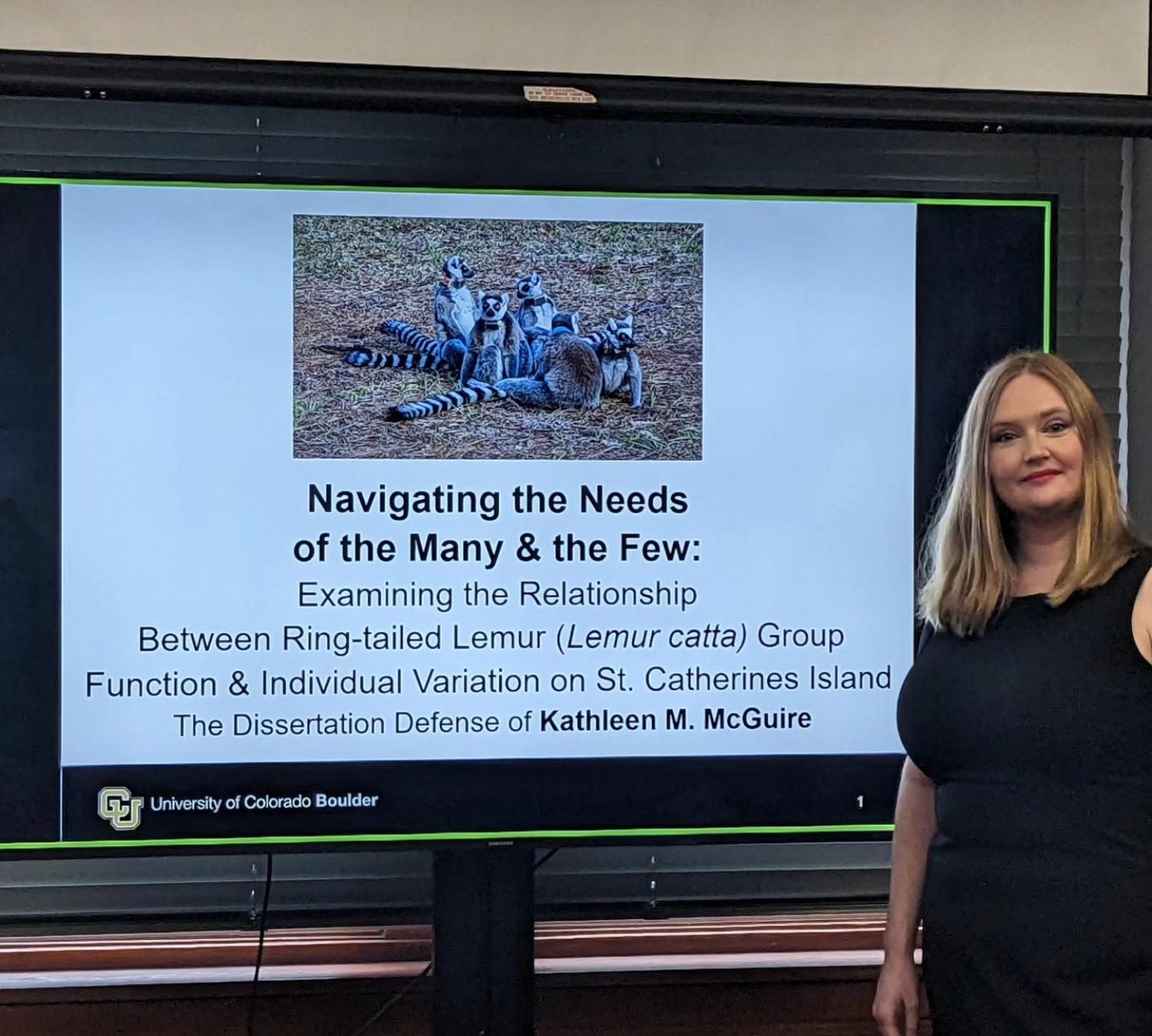 Katie McGuire in front of her PowerPoint