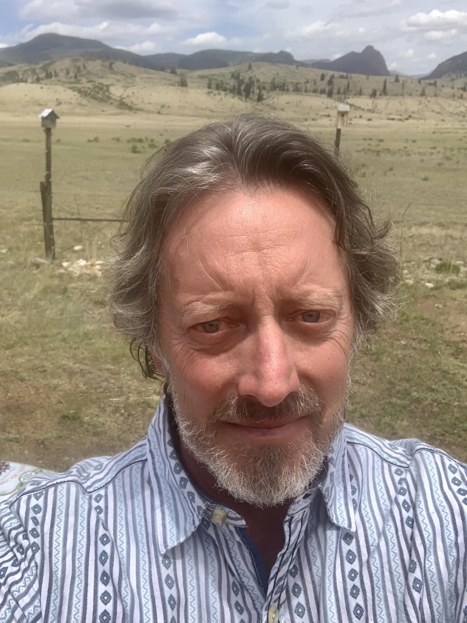 Jerry Jacka with mountains in the background