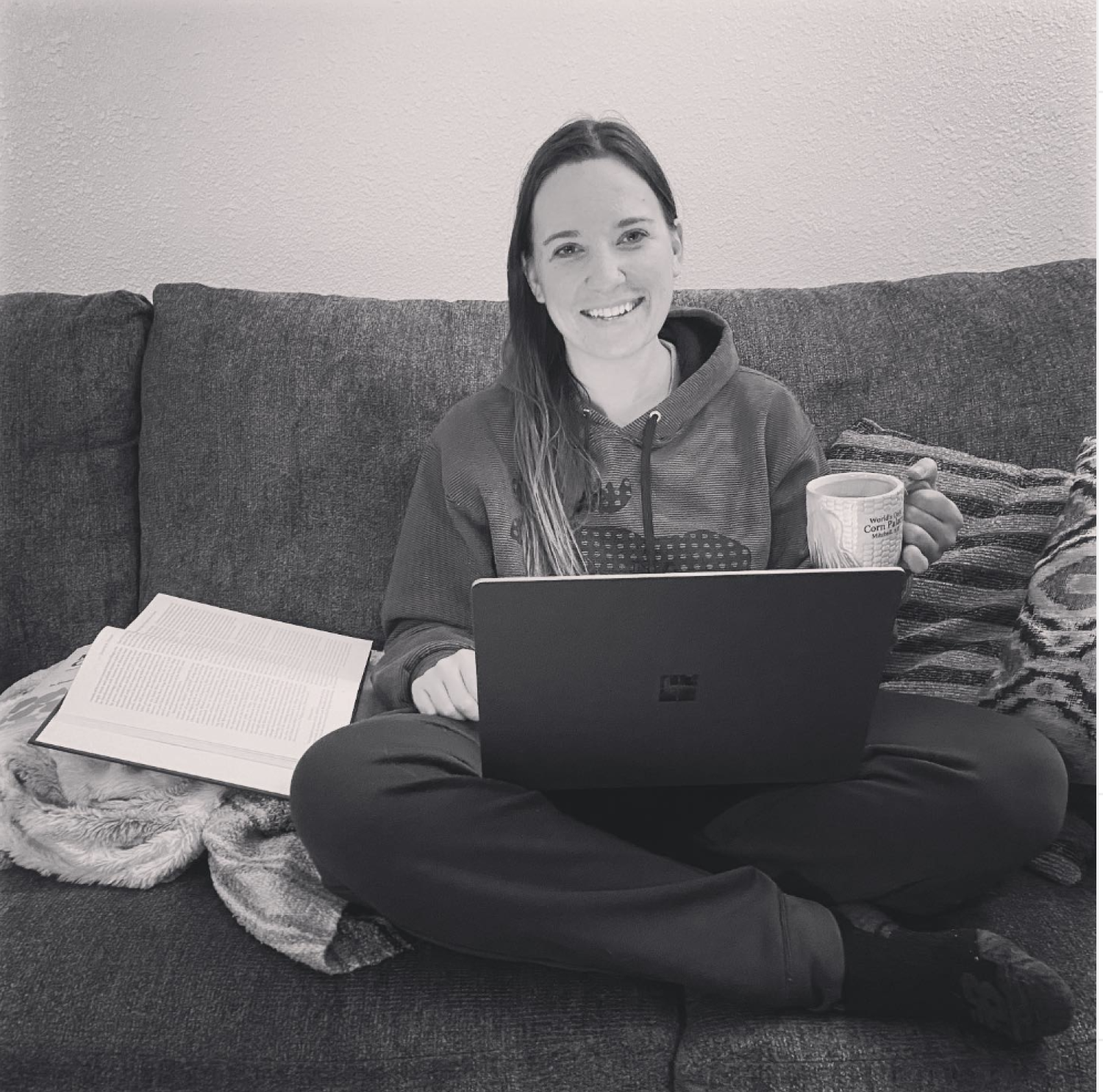 Kelsey on the couch with her laptop