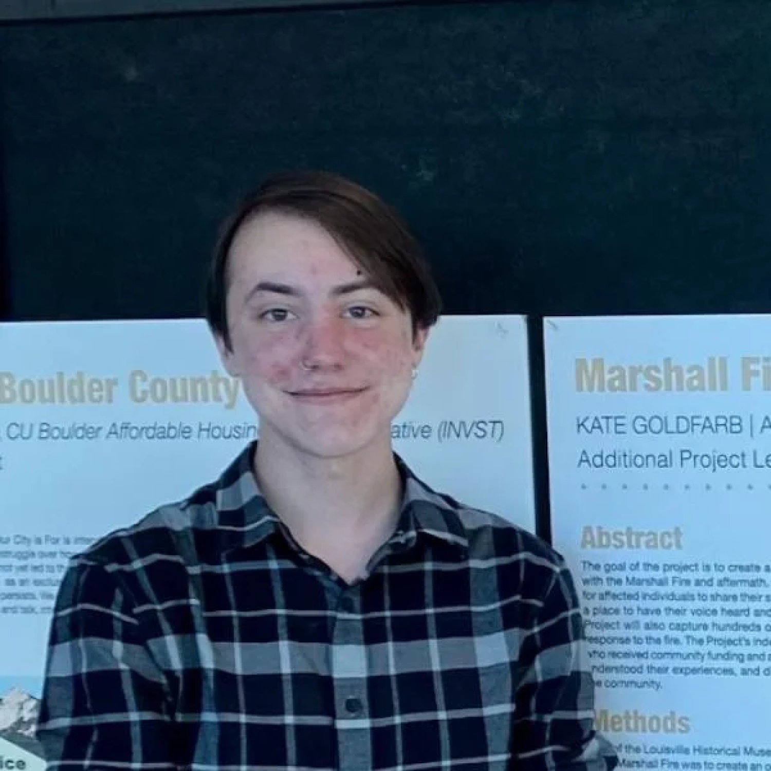 Lucas in front of a poster