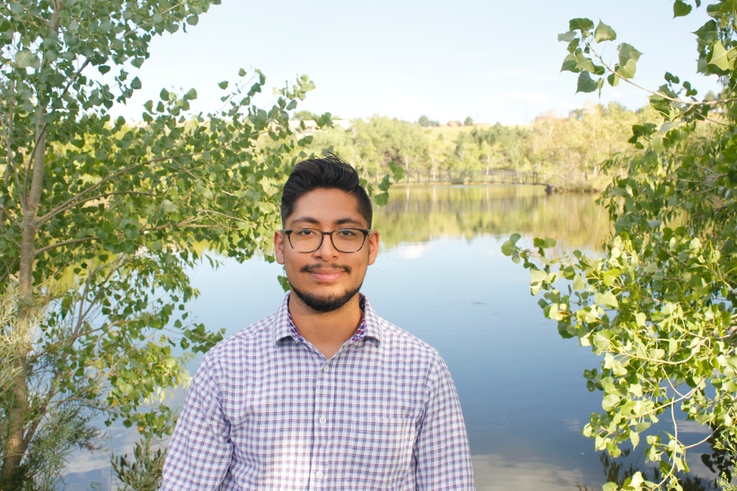Nicholas in front of a pond