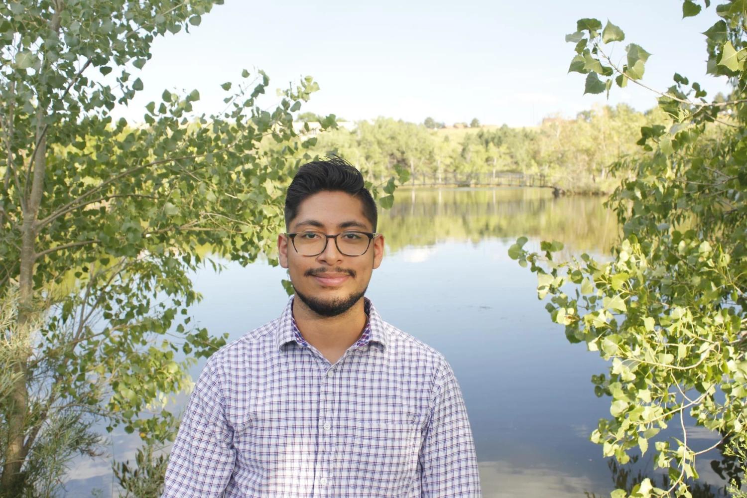 Nicholas in front of a pond