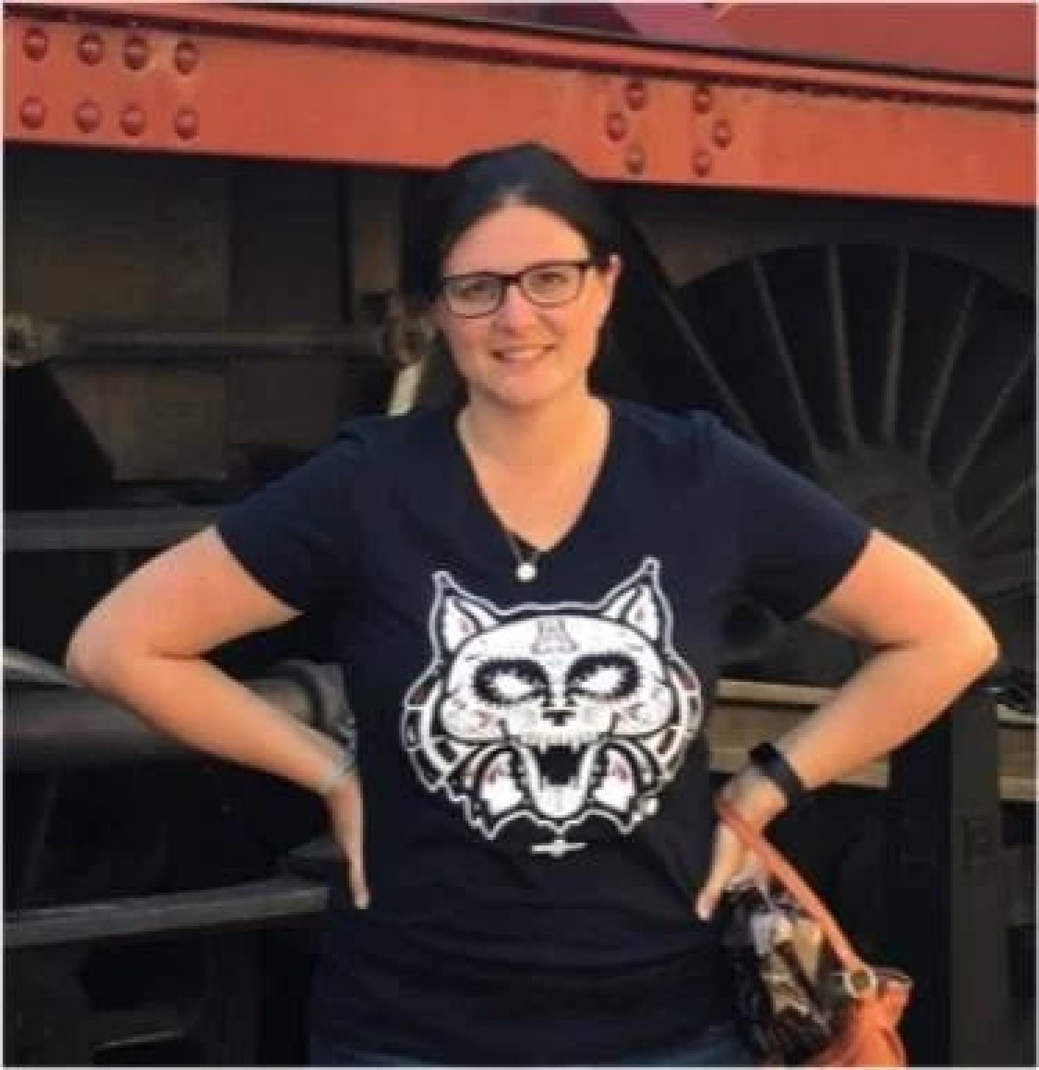 Sam Fladd Standing in front of a train