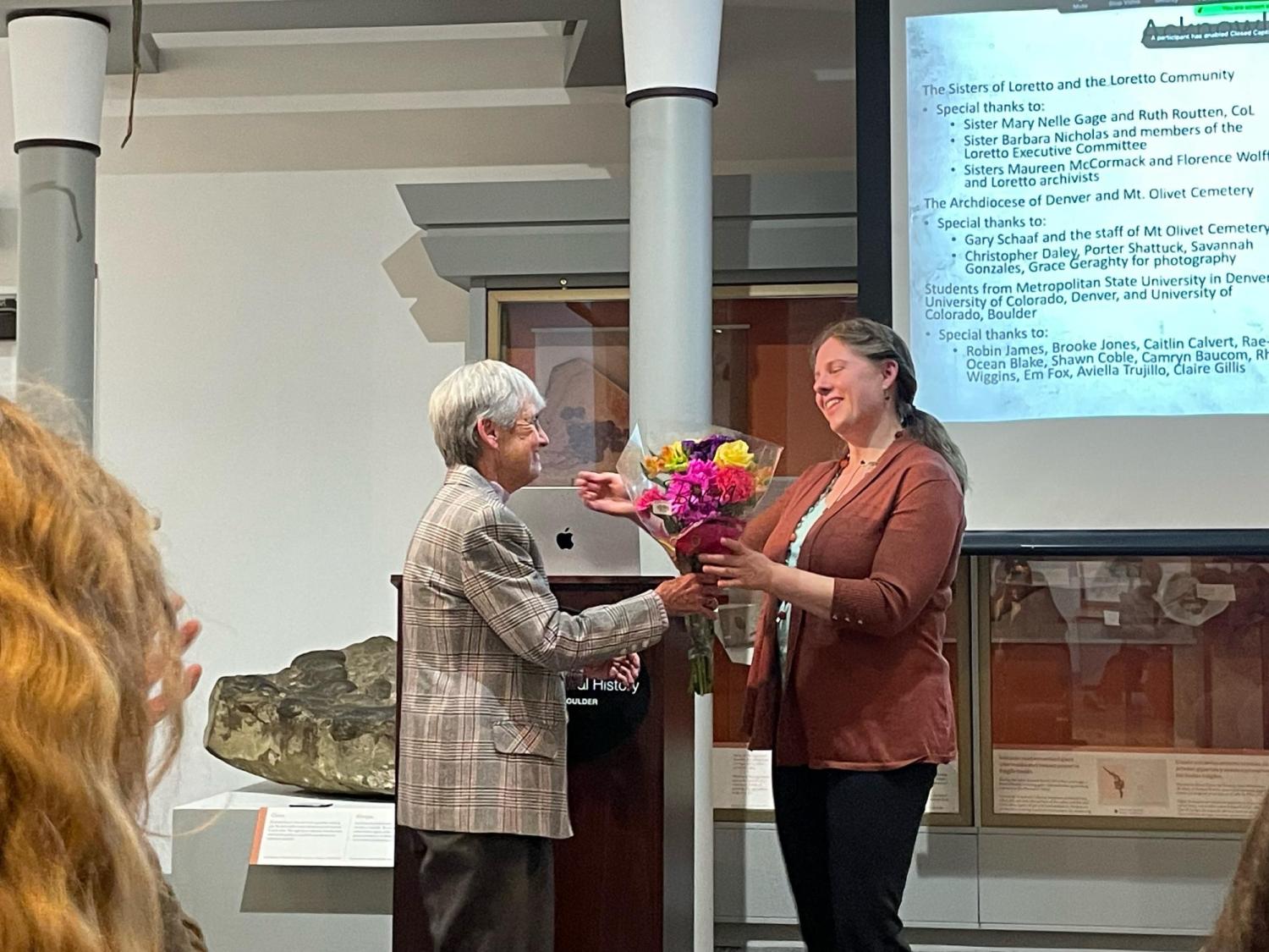 Professor Hosek receiving flowers from the Sisters of Loretto