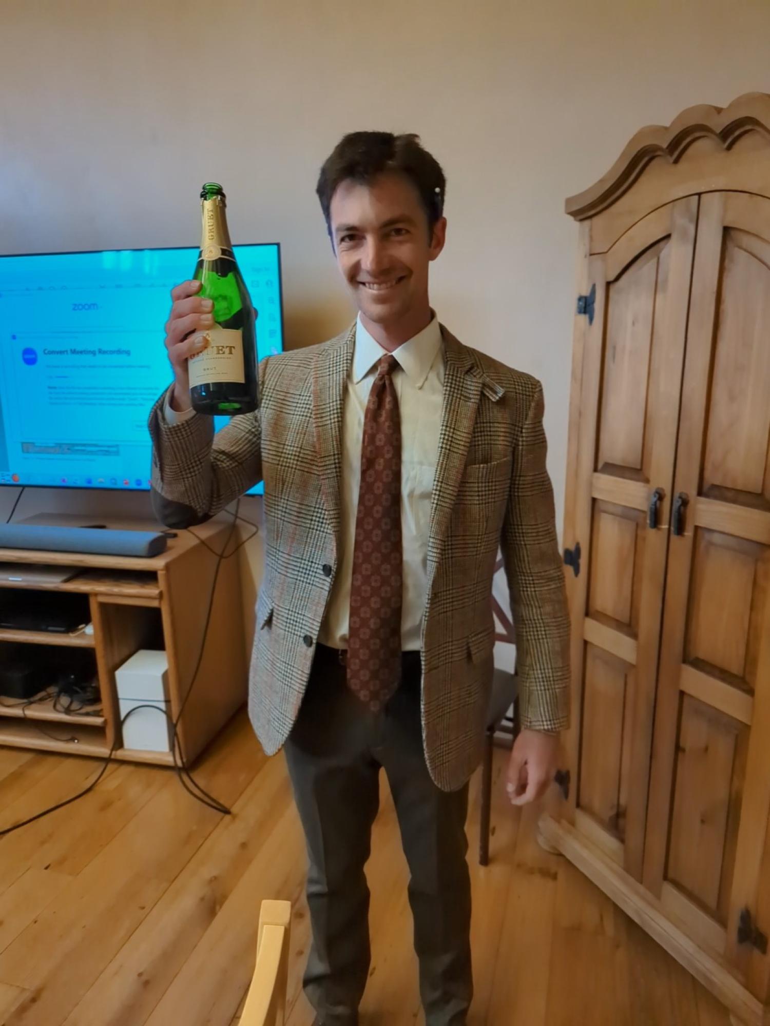 Rob Weiner toasting a champagne bottle