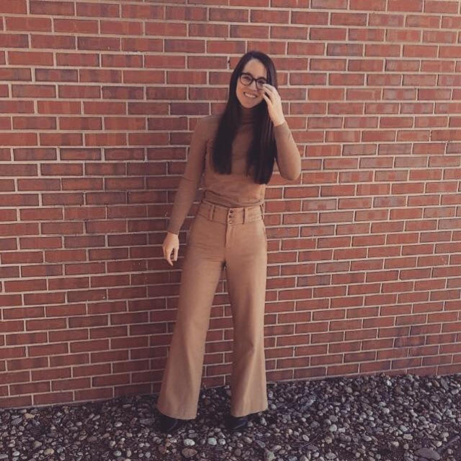 Scarlett Engle in front of a brick wall