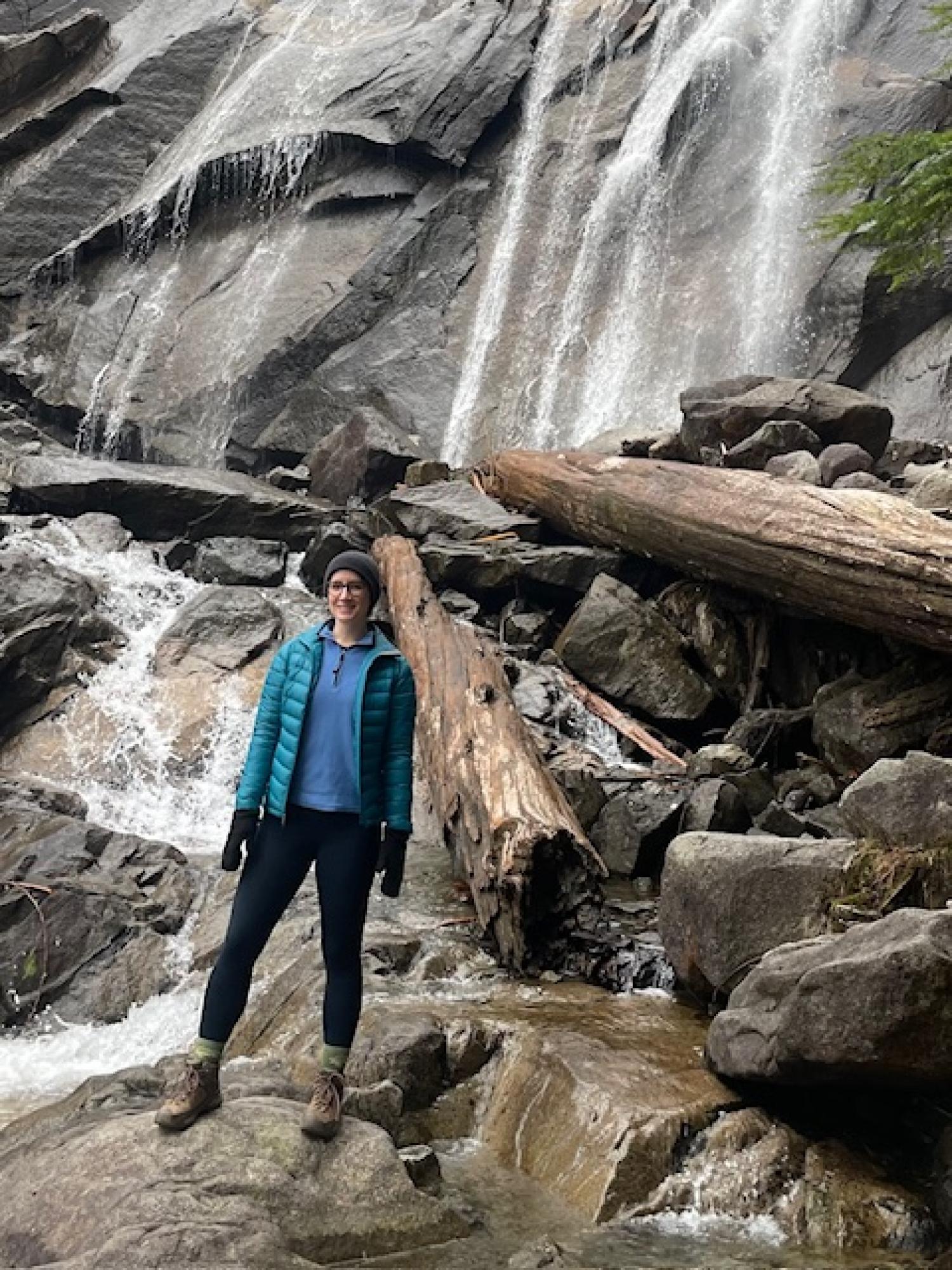 Scarlett in front of a waterfall