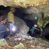 Nicholas in a cave doing research