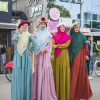 4 women dressed in vibrant dresses