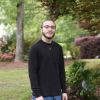 Aaron Lamskin standing next to a tree