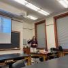 Julie Thomas in front of PowerPoint Screen
