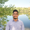 Nicholas in front of a pond